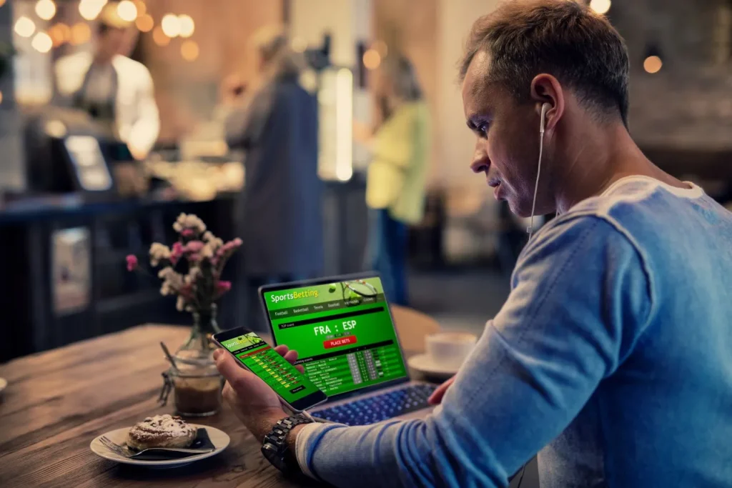 Ruhiger Mann bei der Abgabe von Sportwetten als Zeichen für besonnene Wetten, um mit Sportwetten Geld verdienen zu können